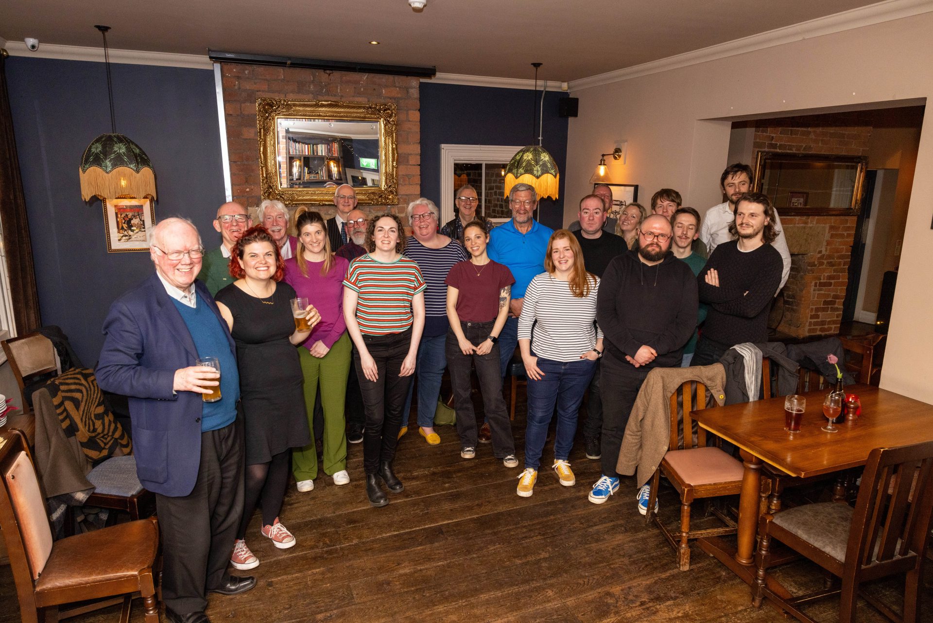 A group of journalists posing awkwardly for a photo in the top room of the Midnight Bell in Leeds.