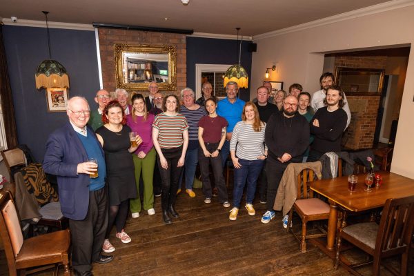 A group of journalists posing awkwardly for a photo in the top room of the Midnight Bell in Leeds.