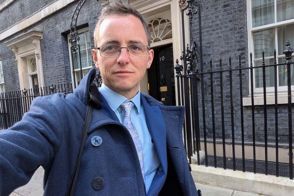 Selfie taken by man in suit outside 10 Downing Street.