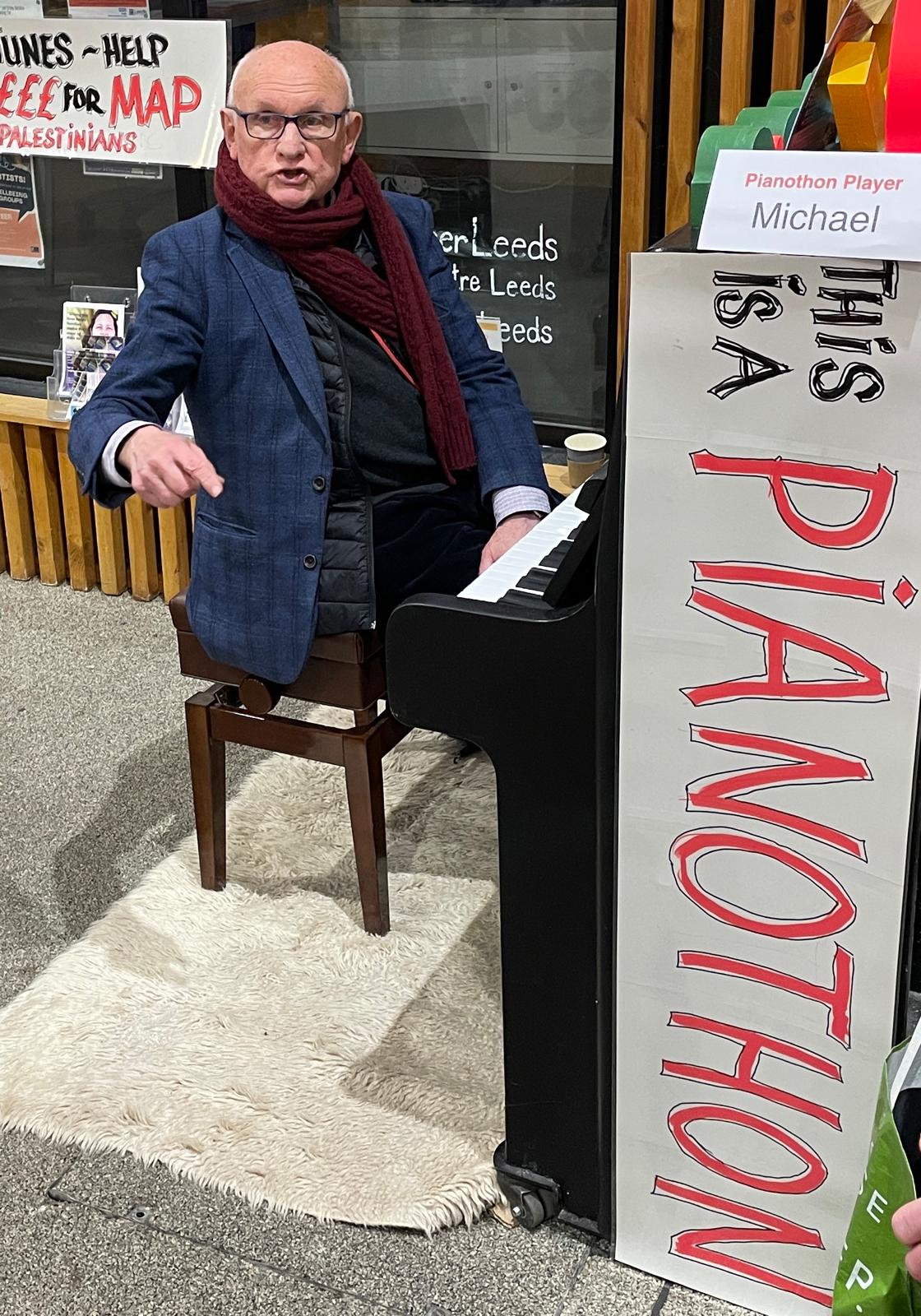 A man playing the piano with 'This is a Pianothon' written on the side